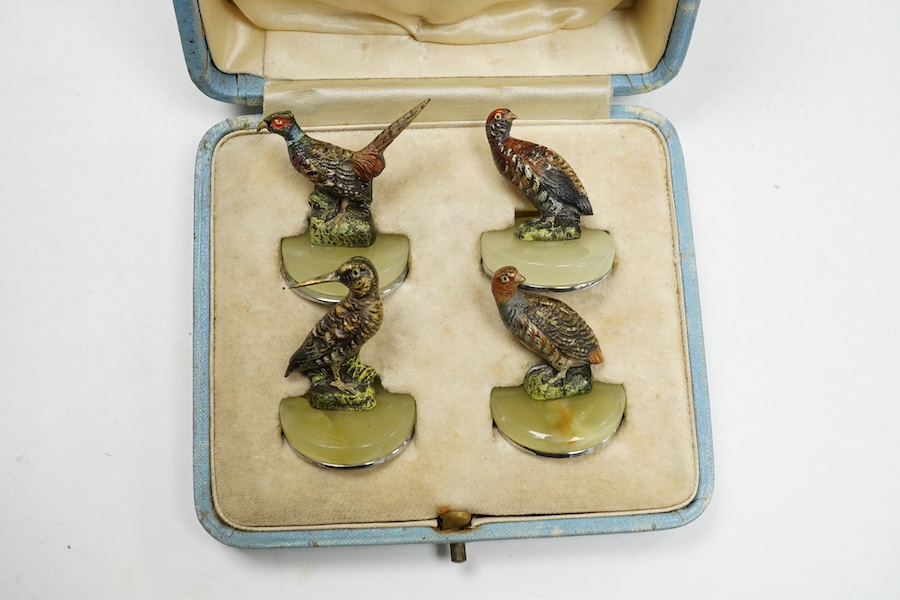 A cased Asprey set of four cold painted bronze and chrome plated novelty game bird menu holders, tallest 5cm high. Condition - good